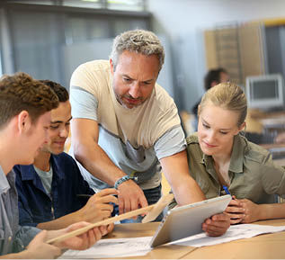 Teacher with group of students working on digital tablet